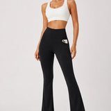 SparkNine Solara flare broek - M - zwart - hoge taille - uitlopend - voorzakken - stijlvol & comfortabel